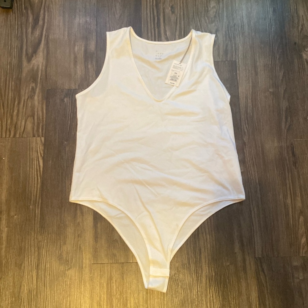 NWT white no sleeve body suit